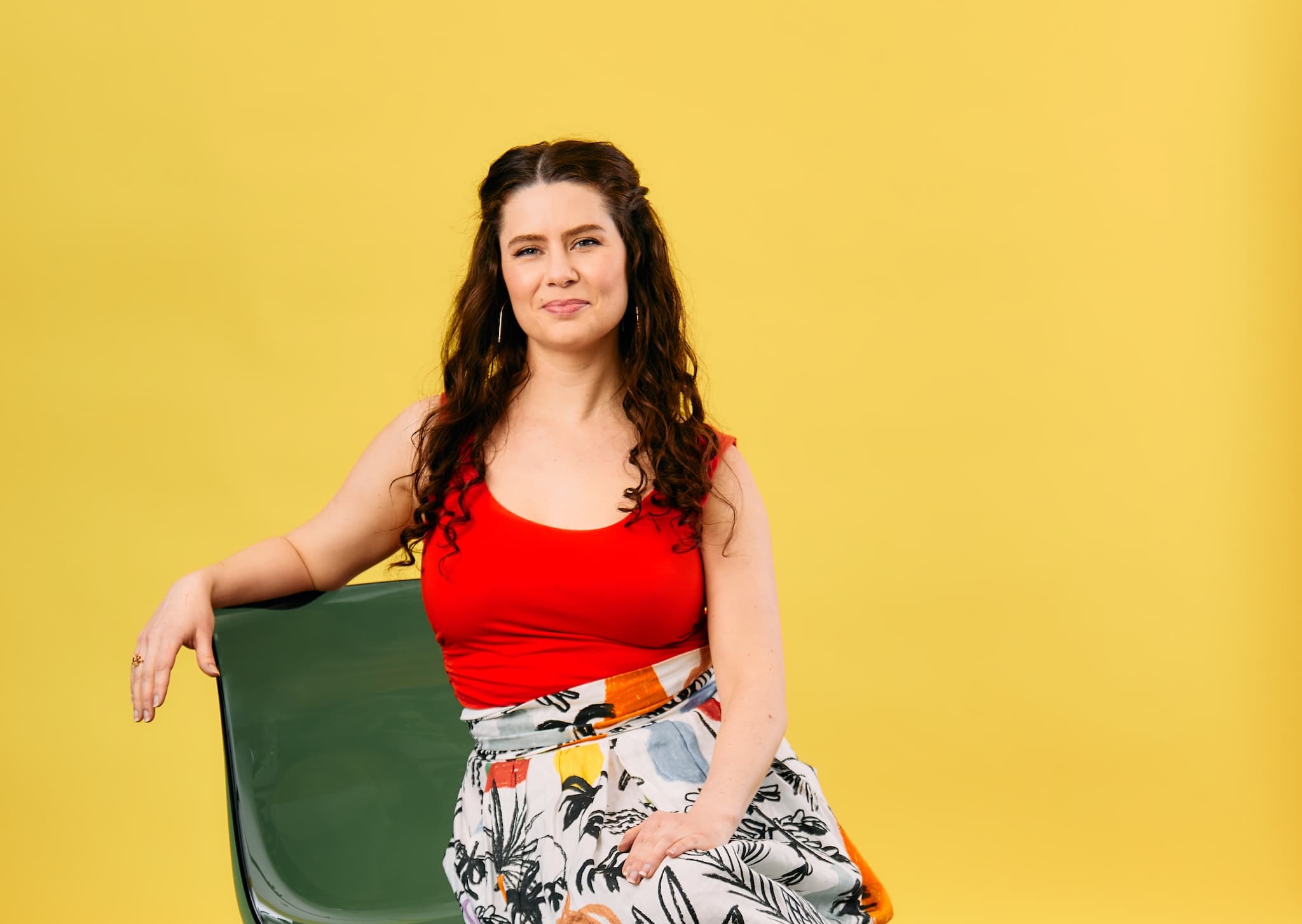 portrait of Kaitlin smiling and wearing vivid colors